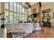 Bright Gathering room with stone fireplace, vaulted ceiling, and expansive windows at 962 Chattooga Trce, Suwanee, GA 30024