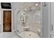 Spacious walk-in shower with marble tile and glass enclosure at 962 Chattooga Trce, Suwanee, GA 30024