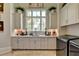 Bright laundry room featuring ample cabinetry and a large window at 962 Chattooga Trce, Suwanee, GA 30024