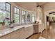 White kitchen features a farmhouse sink, marble countertops, and ample cabinetry at 962 Chattooga Trce, Suwanee, GA 30024