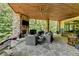 Relaxing stone patio with fireplace, seating area, and ceiling fan at 962 Chattooga Trce, Suwanee, GA 30024