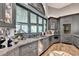 Modern home bar with gray cabinetry and expansive windows at 962 Chattooga Trce, Suwanee, GA 30024