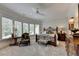 Large bedroom with bay window, ceiling fan, and carpeting at 962 Chattooga Trce, Suwanee, GA 30024