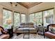 Relaxing sitting area with a bay window, leather sofa, and unique ceiling at 962 Chattooga Trce, Suwanee, GA 30024