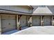 Four-car garage with gray doors and metal roofing at 962 Chattooga Trce, Suwanee, GA 30024