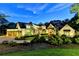 Luxury home exterior at dusk with landscaping and circular driveway at 962 Chattooga Trce, Suwanee, GA 30024