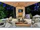 Evening view of the covered patio with fireplace and seating at 962 Chattooga Trce, Suwanee, GA 30024