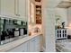 Built-in coffee bar with marble countertops and white shaker cabinets at 962 Chattooga Trce, Suwanee, GA 30024