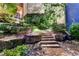 Stone steps and lush landscaping leading to the home entrance at 962 Chattooga Trce, Suwanee, GA 30024