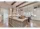 Gourmet kitchen with hardwood floors, white cabinets, and large island at 962 Chattooga Trce, Suwanee, GA 30024