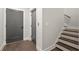 Modern basement stairwell with dark hardwood steps and gray doors at 1420 Coretta Bend, Atlanta, GA 30318