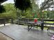 Relaxing deck with table and chairs, offering a wooded view at 2023 Lee Dr, Austell, GA 30168