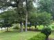 Landscaped side yard with mature trees and lush greenery at 2023 Lee Dr, Austell, GA 30168