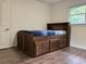 Well-lit bedroom with built-in storage and wood flooring at 2023 Lee Dr, Austell, GA 30168