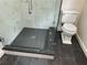 Bathroom with a large walk-in shower and dark tile floor at 2023 Lee Dr, Austell, GA 30168