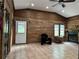 Charming sunroom with wood-paneled walls and a wood-burning fireplace at 2023 Lee Dr, Austell, GA 30168