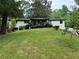Mid-century modern ranch house featuring a freshly painted exterior and deck at 2023 Lee Dr, Austell, GA 30168