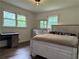 Cozy bedroom with hardwood floors, large windows and a dresser at 2023 Lee Dr, Austell, GA 30168