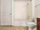 Bathroom with tub, toilet, and tiled walls at 230 E Ponce De Leon Ave # 322, Decatur, GA 30030