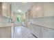 Bright laundry room with white cabinets and hexagon tile floors at 1235 Mount Paran Nw Rd, Atlanta, GA 30327