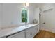 White wet bar with quartz countertop and sink, offering additional storage at 1235 Mount Paran Nw Rd, Atlanta, GA 30327