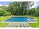 Inviting in-ground pool with spa, surrounded by lush landscaping at 1235 Mount Paran Nw Rd, Atlanta, GA 30327