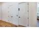 Bright hallway with two white doors and light oak hardwood floors at 1235 Mount Paran Nw Rd, Atlanta, GA 30327