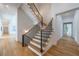 Stunning staircase with a modern, wrought iron railing and hardwood floors at 1235 Mount Paran Nw Rd, Atlanta, GA 30327