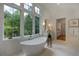 Luxury bathroom with a free standing tub and large windows at 1235 Mount Paran Nw Rd, Atlanta, GA 30327