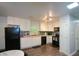 Modern kitchen featuring white cabinetry, black appliances, and mosaic tile backsplash at 7427 W Fayetteville Rd, Riverdale, GA 30296