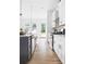 Modern kitchen with white cabinets, island, and stainless appliances at 597 Federal Se Ter, Atlanta, GA 30315