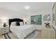 Main bedroom with king-size bed, light wood floors, and neutral decor at 4254 River Green Nw Dr # 616, Atlanta, GA 30327