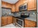 Updated kitchen features granite countertops and stainless steel appliances at 3599 Woodbriar Cir # E, Tucker, GA 30084