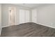 Primary bedroom with double closets and wood-look floors at 3599 Woodbriar Cir # E, Tucker, GA 30084