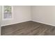 Well-lit bedroom featuring wood-look floors and a window at 3599 Woodbriar Cir # E, Tucker, GA 30084