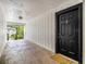 Shared entryway with one black door and welcome mat at 3599 Woodbriar Cir # E, Tucker, GA 30084