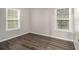 Charming bedroom with two windows and wood-look floors at 3599 Woodbriar Cir # E, Tucker, GA 30084