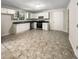 Bright kitchen with white cabinets, stainless steel appliances, and tile flooring at 101 Dodd St, Fairburn, GA 30213