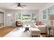 Living room with hardwood floors, large windows, and a cozy seating area at 1941 Wells Sw Dr, Atlanta, GA 30311