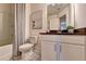 Clean bathroom with a shower/tub combo and dark vanity at 2535 Riverside Rd, Conyers, GA 30013