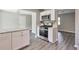 Updated kitchen with white cabinets, stainless steel appliances, and gray flooring at 910 Michael Dr, Atlanta, GA 30349