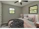 Comfortable bedroom with ceiling fan and large window, furnished with modern bed at 910 Michael Dr, Atlanta, GA 30349