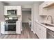 Renovated kitchen boasting stainless steel appliances and white shaker cabinets at 910 Michael Dr, Atlanta, GA 30349