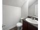 Bathroom with dark vanity, single sink, and toilet at 313 Lauren Dr, Fairburn, GA 30213