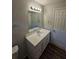 Bright bathroom with vanity, mirror, and updated flooring at 4670 Eberline Ct, Stone Mountain, GA 30083