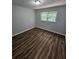 Spacious bedroom with wood-look flooring and window at 4670 Eberline Ct, Stone Mountain, GA 30083