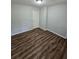 Bright bedroom featuring wood-look floors and an interior door at 4670 Eberline Ct, Stone Mountain, GA 30083