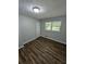 Well-lit bedroom with wood-look floors and an interior door at 4670 Eberline Ct, Stone Mountain, GA 30083