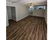 Large living room with hardwood floors and access to kitchen at 4670 Eberline Ct, Stone Mountain, GA 30083