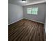 Spacious bedroom with wood-look flooring and large windows at 4670 Eberline Ct, Stone Mountain, GA 30083